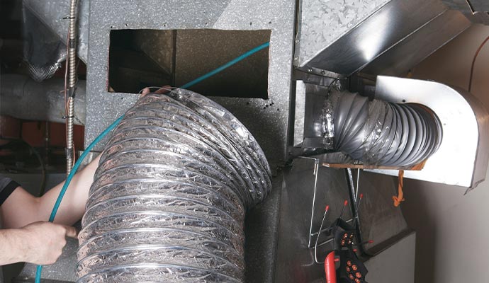 Air duct cleaning service in progress