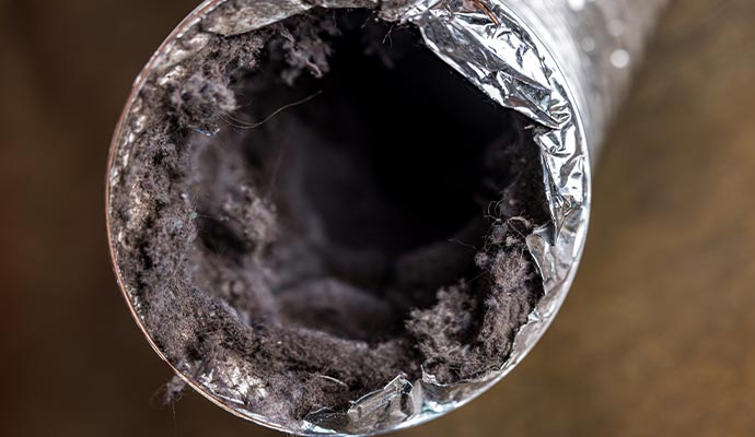 Close-up view of a clogged dryer vent