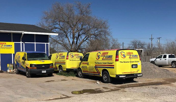Lubbock Steamer service vehicles Lubbock Steamer service vehicles parked outside a building