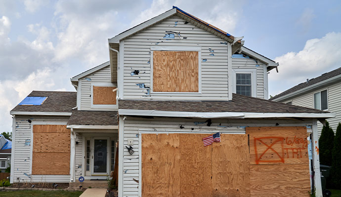 Boarded up hail damaged house