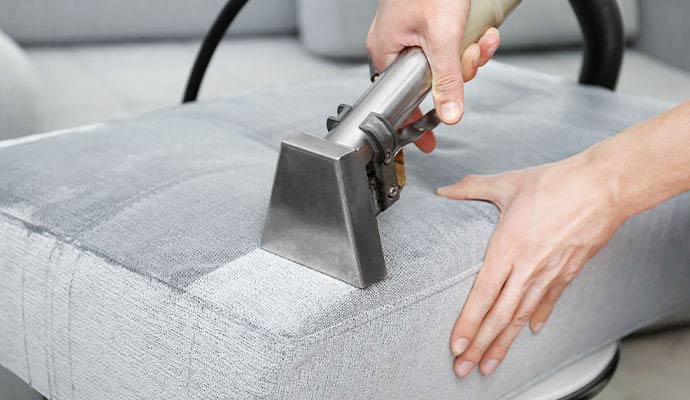 Upholstery cleaning service using equipment
