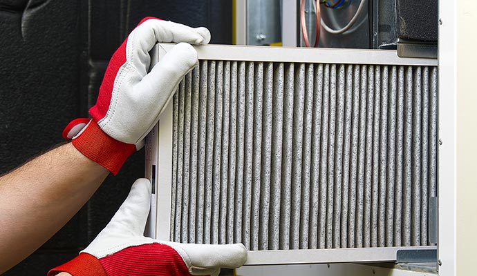 A person replacing HVAC filter A person replacing HVAC filter