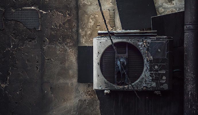 Damaged outdoor air conditioning unit Damaged outdoor air conditioning unit