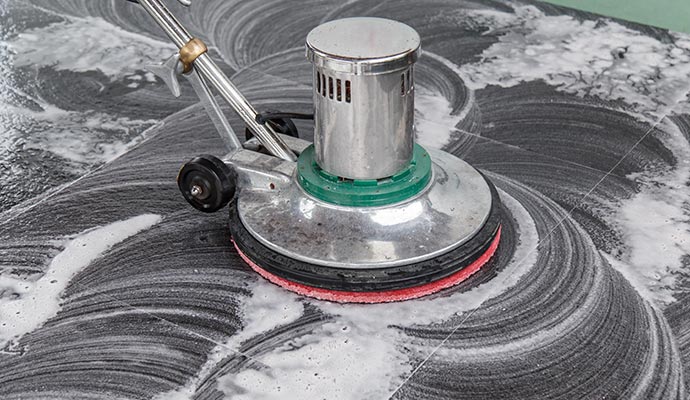 A person cleaning floor using professional equipment